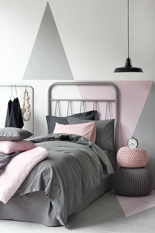 ottoman s in pink and grey used as a bedside table and simple bedding ...