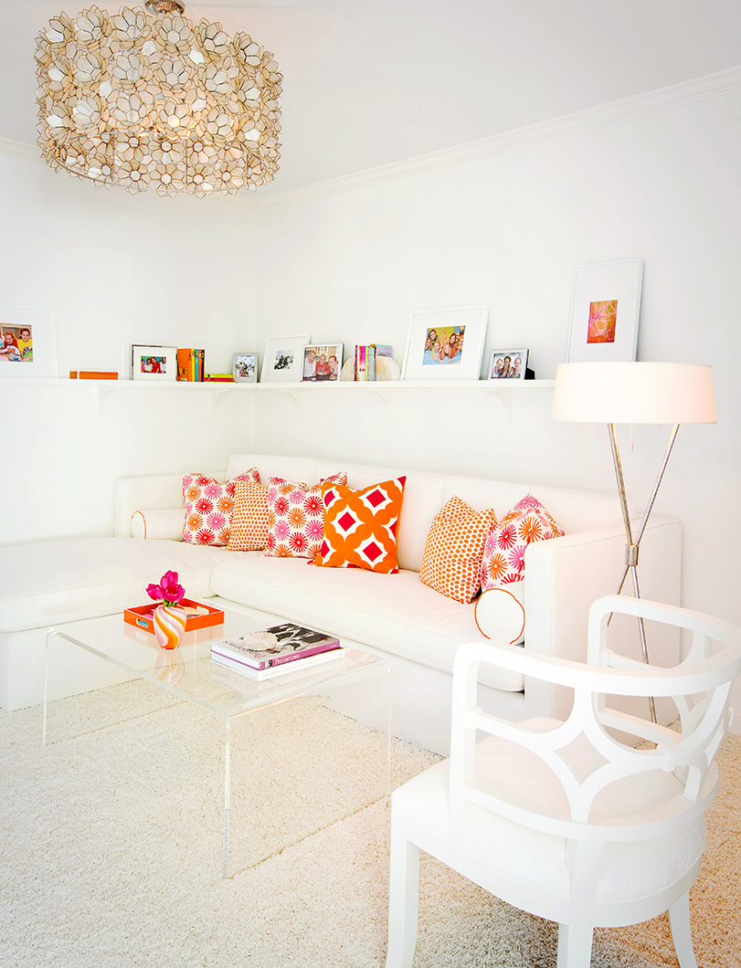 white sofa with orange and pink pillows