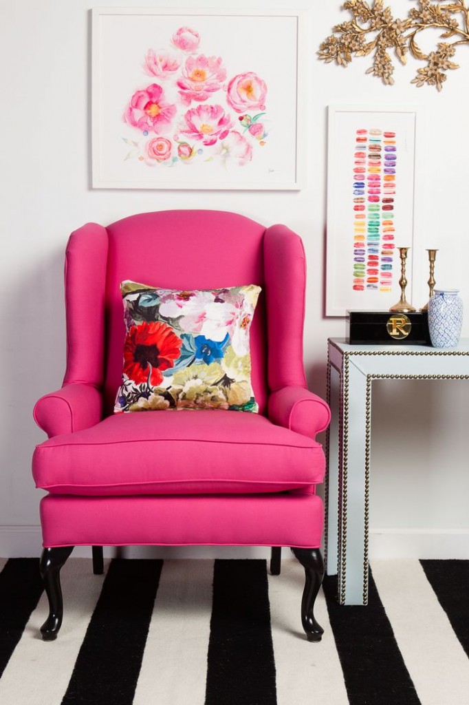 pink armchair and black white stipe floor