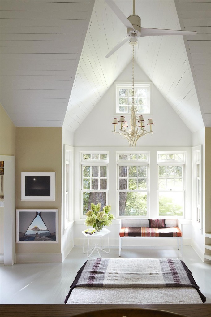 In the master bedroom, the chandelier and bench, which is covered with blankets bought during a photo shoot in Bolivia, are flea-market finds, and the photographs are by Mark Klett; the walls are painted in Benjamin Moore Aura in Dune White, and the ceiling in Aura in Chalk White.