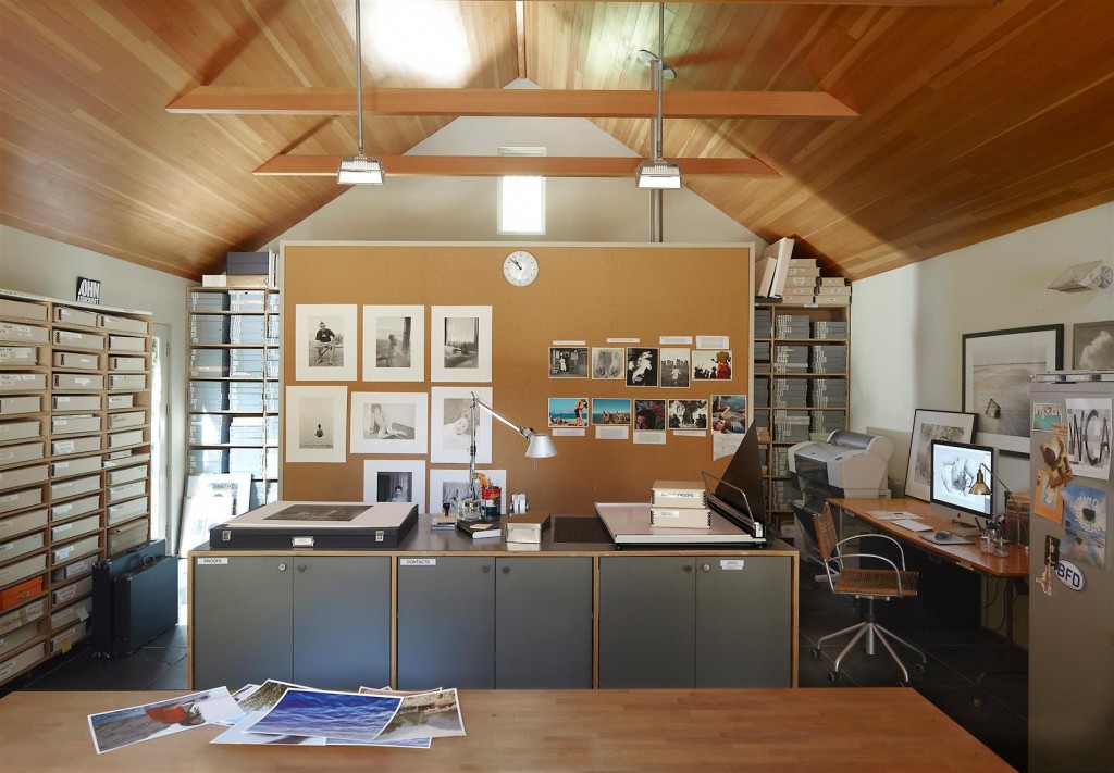 A custom-made cabinet and desk in the office; the table lamp is by Artemide, and the ceiling is stained fir.