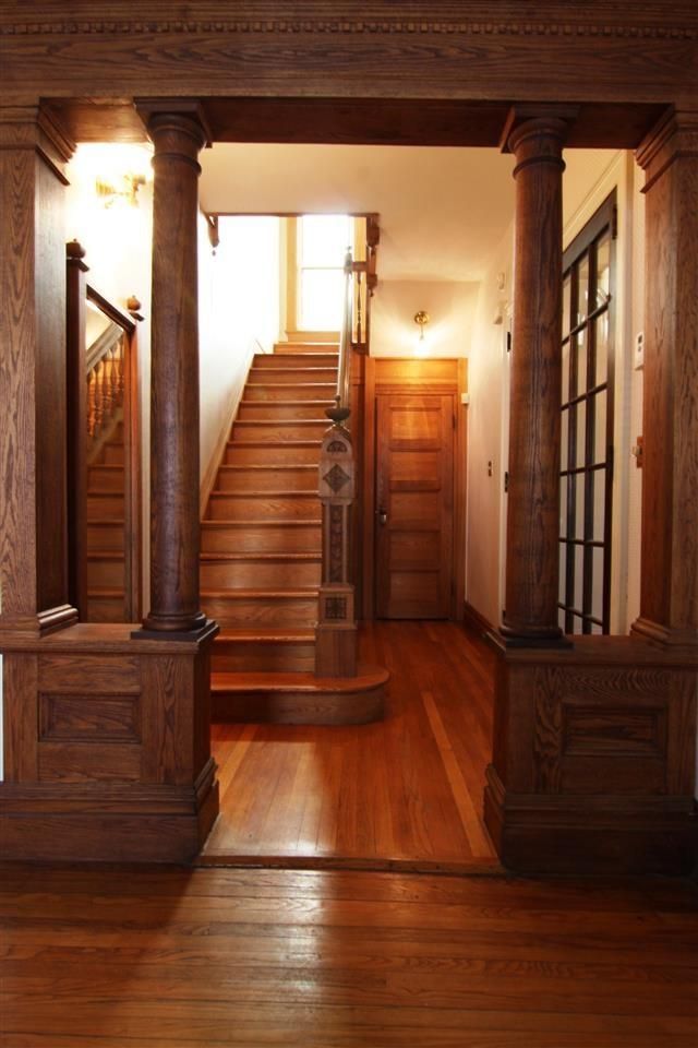 Hallway with columns and staircase with a carved newel post in a Victorian (1890) house - 272 Albany Ave, Kingston, NY