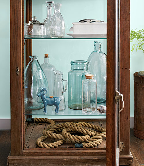 glass cabinet with vases inside