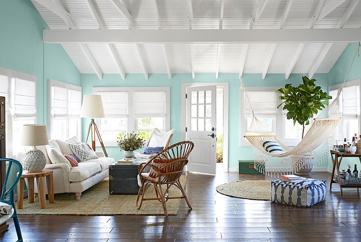white painted rafters and aqua walls living room