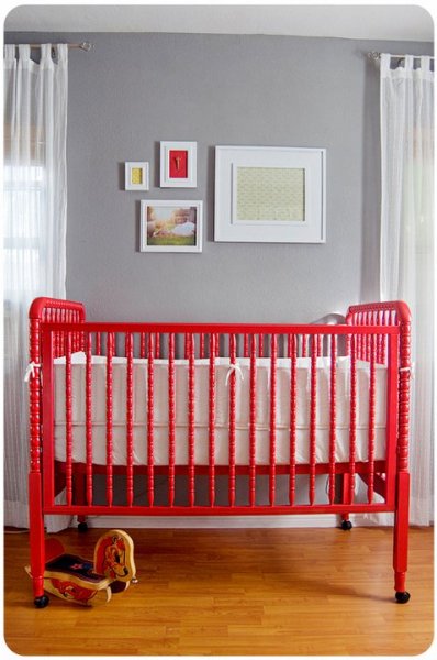 Vintage style red crib with gray walls nursery