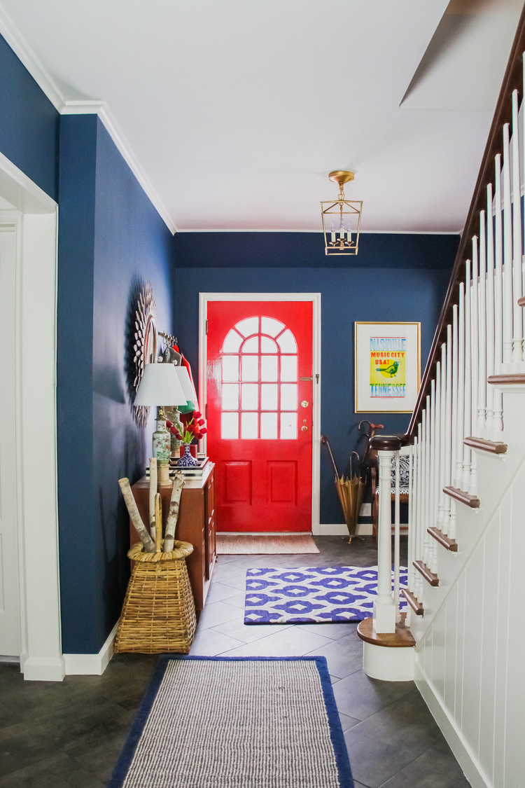 Entrance with walls painted in Benjamin Moore Washington Blue and red painted door.