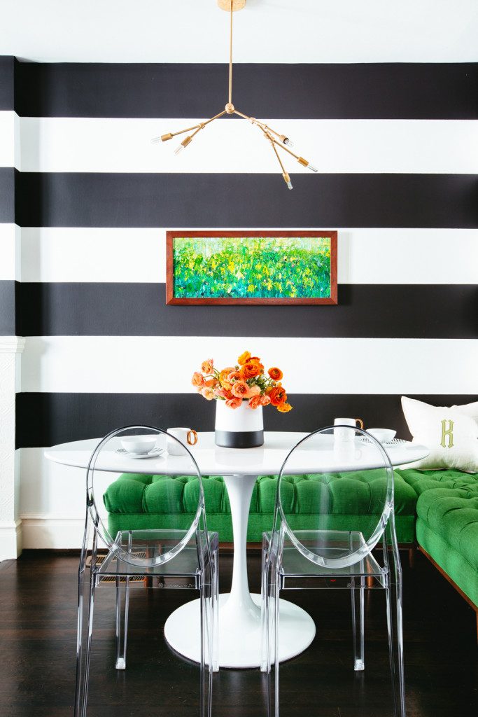Noz Nozawa of Noz Design created a dramatic backdrop for a glam breakfast nook using stripes in different finishes. Kelly Green settee. via Colin Price Photography