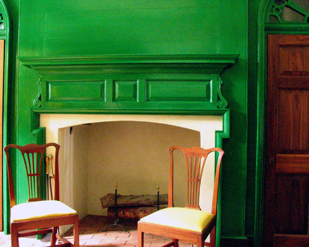 Historical home wall and fireplace painted in a bright green similar to Sherwin WIlliams Jolly Green