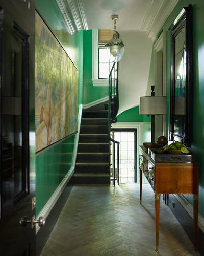 kelly Green painted walls in the entrance and staircase. via Elle decor