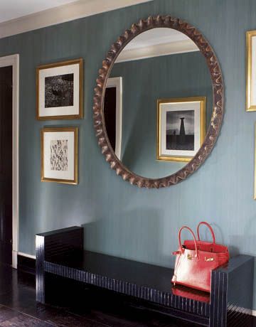 Albert Hadley: A scalloped wood-and-gesso mirror above a lacquered bench in the foyer shows the reflection of a photograph taken in Peru by the American photographer Louise Dahl-Wolfe, famous for her Harper's Bazaar fashion work.