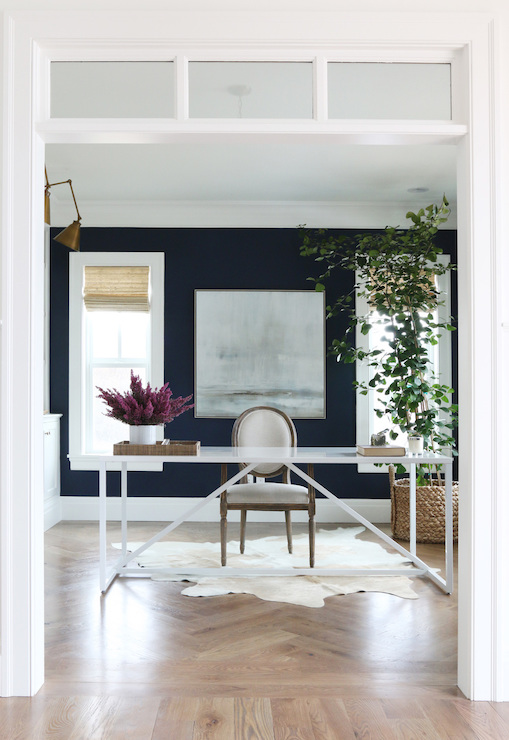 Home office walls painted in Benjamin Moore Deep Royal with white trim, rug and desk.