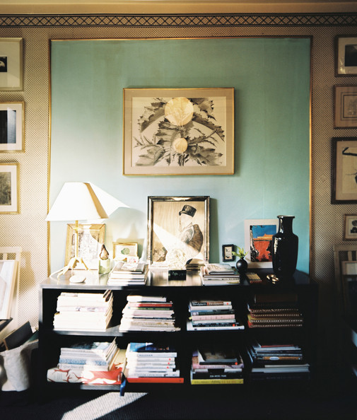 A black console against a wall with a blue accent trimmed with gold molding Details: Beige Eclectic-Modern Living Room