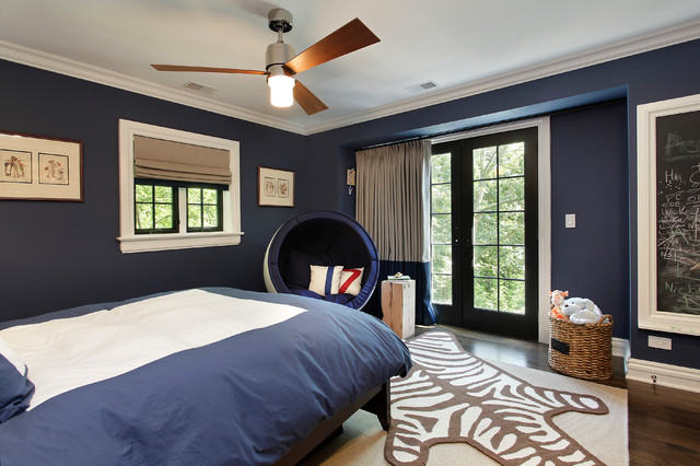Contemporary boys bedroom with a navy blue color scheme with walls painted in Benjamin Moore Van Deusen Blue