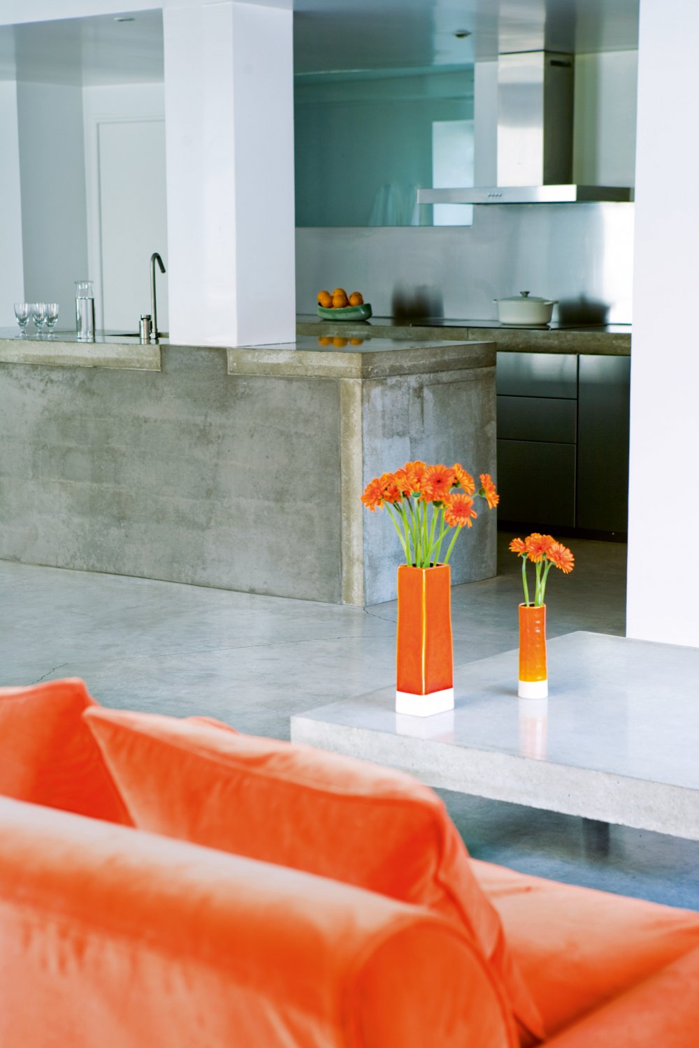 concrete and orange kitchen