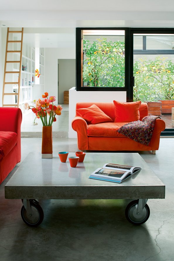 concrete floor and orange couches living