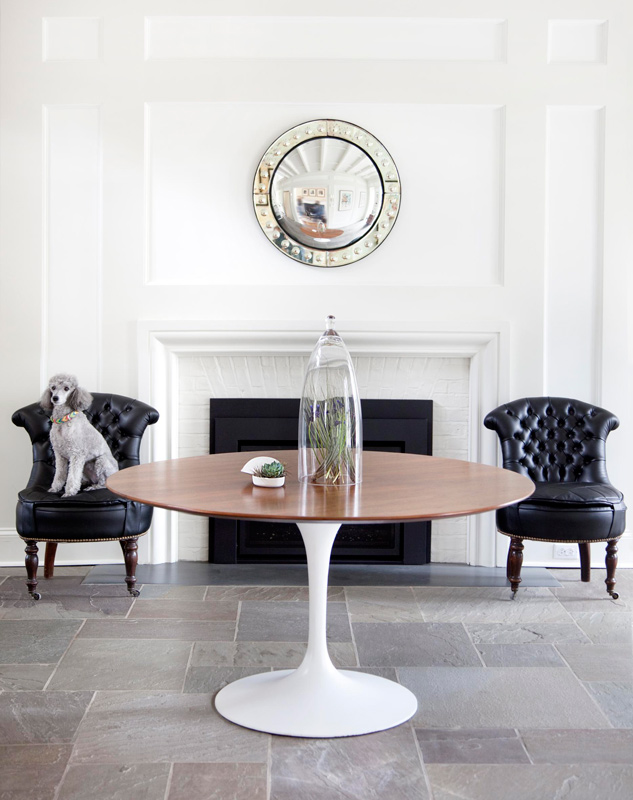 Eclectic space in black and white, white walls, round table