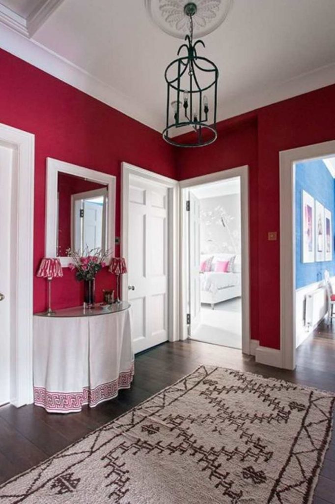 A Traditional hallway with walls painted in Farrow & Ball Rectory Red
