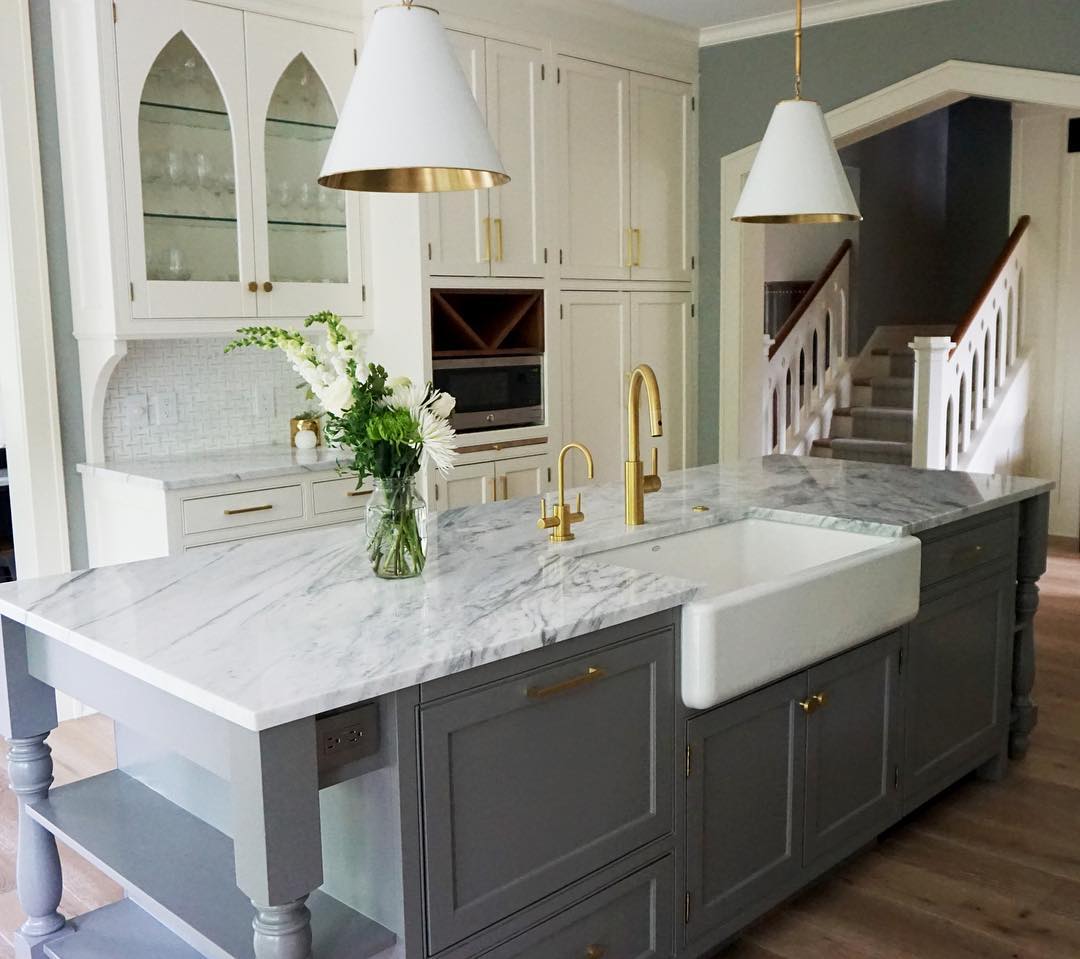 A kitchen in white and shades of gray with the kitchen island painted