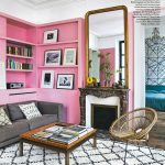Barbie Pink Wall Paint Color. Living room with pink walls and bookshelves, pink paint color scheme