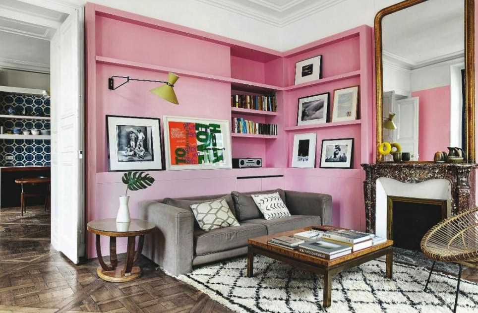 Barbie Pink Wall Paint Color. Living room with pink walls and bookshelves, pink paint color scheme