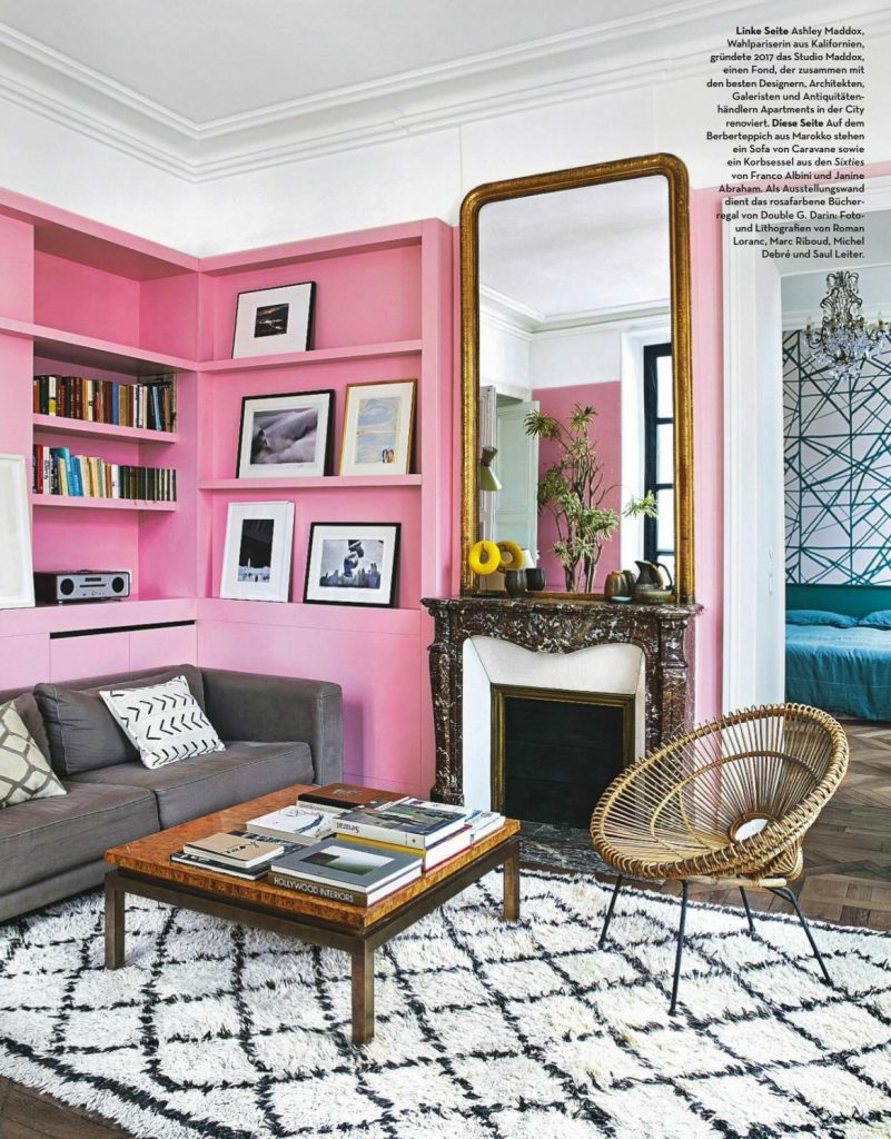 Barbie Pink Wall Paint Color. Living room with pink walls and bookshelves, pink paint color scheme
