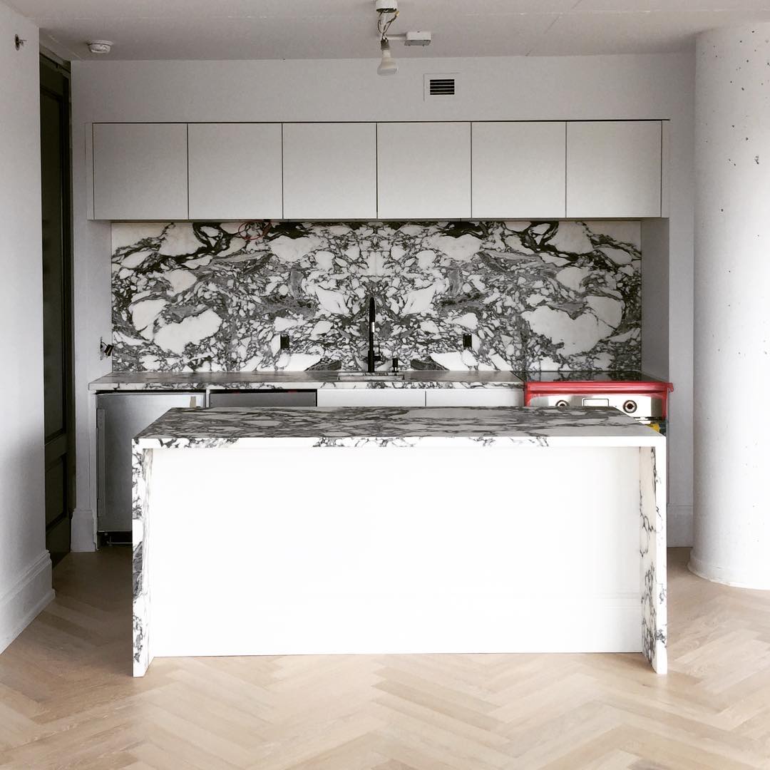 Black and White Marble Kitchen Color Scheme. Timber herringbone flooring kitchen, black taps and hardware.