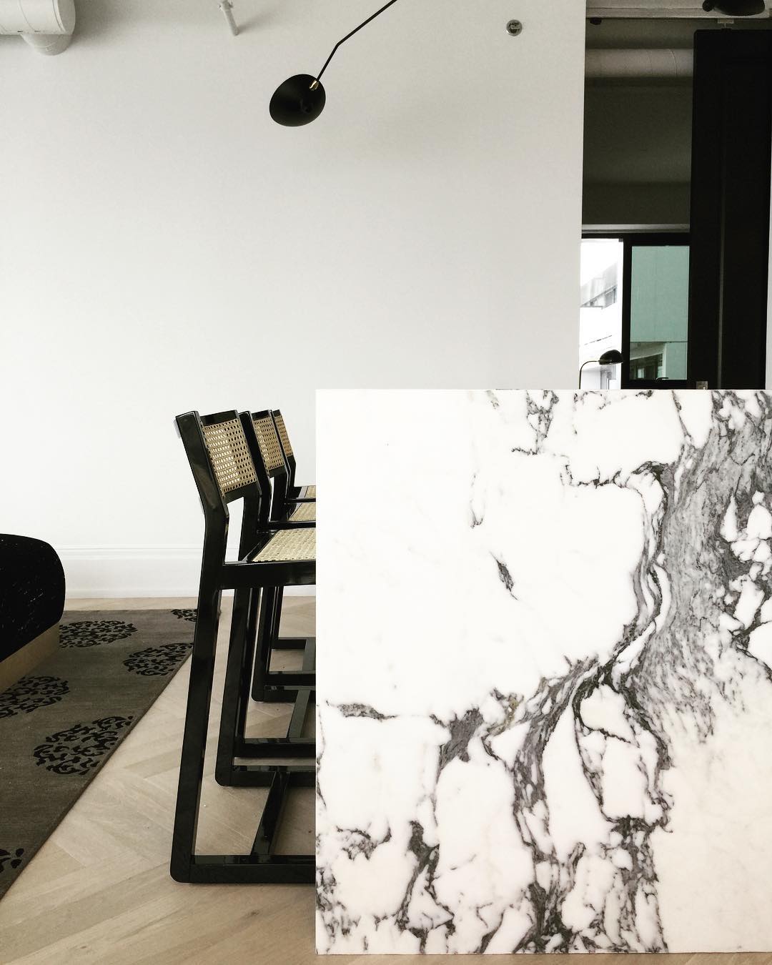 Black and White Marble Kitchen Color Scheme. Timber herringbone flooring kitchen, black taps and hardware.