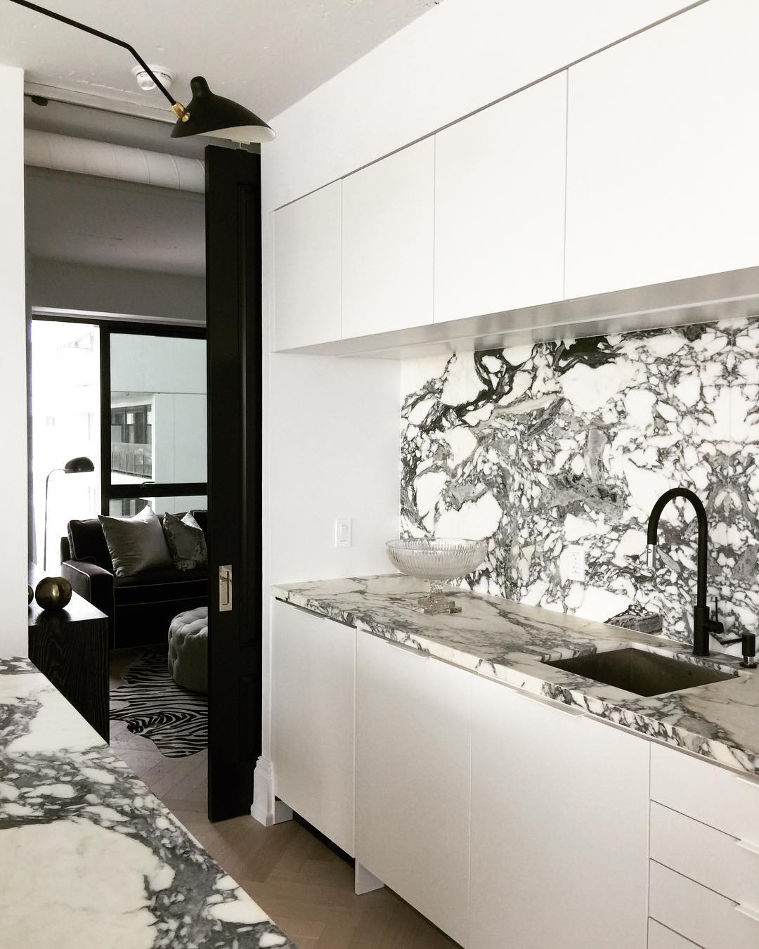 Black and White Marble Kitchen Color Scheme. Timber herringbone flooring kitchen, black taps and hardware.