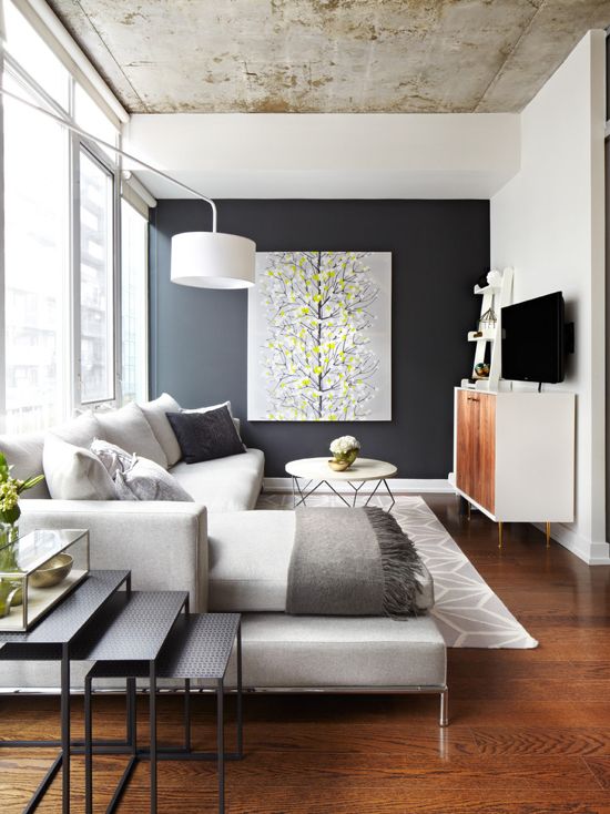 Dark gray feature wall in the modern living room, concrete ceiling, gray paint color scheme