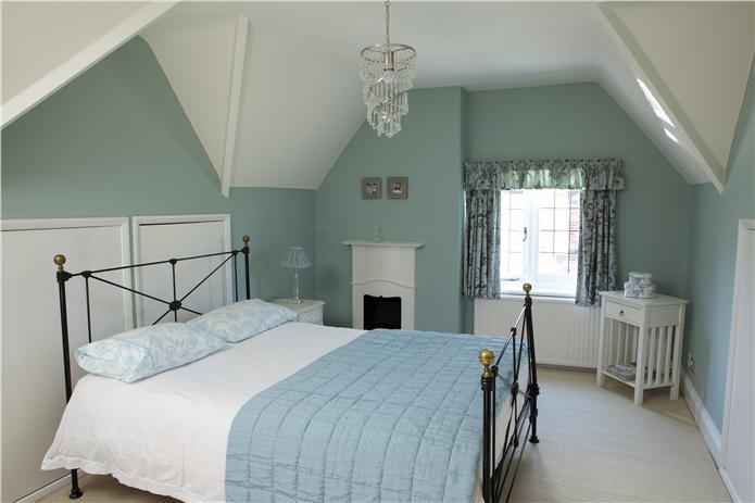 Farrow & Ball Blue Green Painted Bedroom Walls. Muted teal paint color scheme.