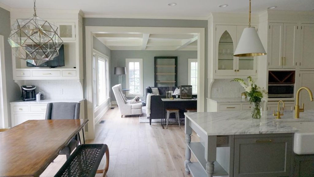 A kitchen in white and shades of gray with the kitchen island painted in Chelsea Gray by Benjamin Moore