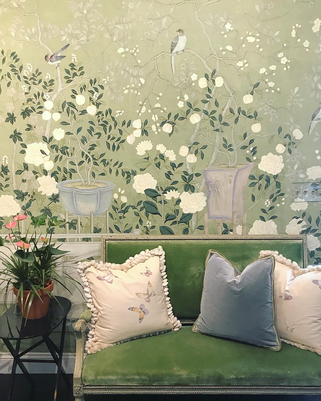 Green interior design color scheme with green velvet settee and Chinoiserie wallpaper.