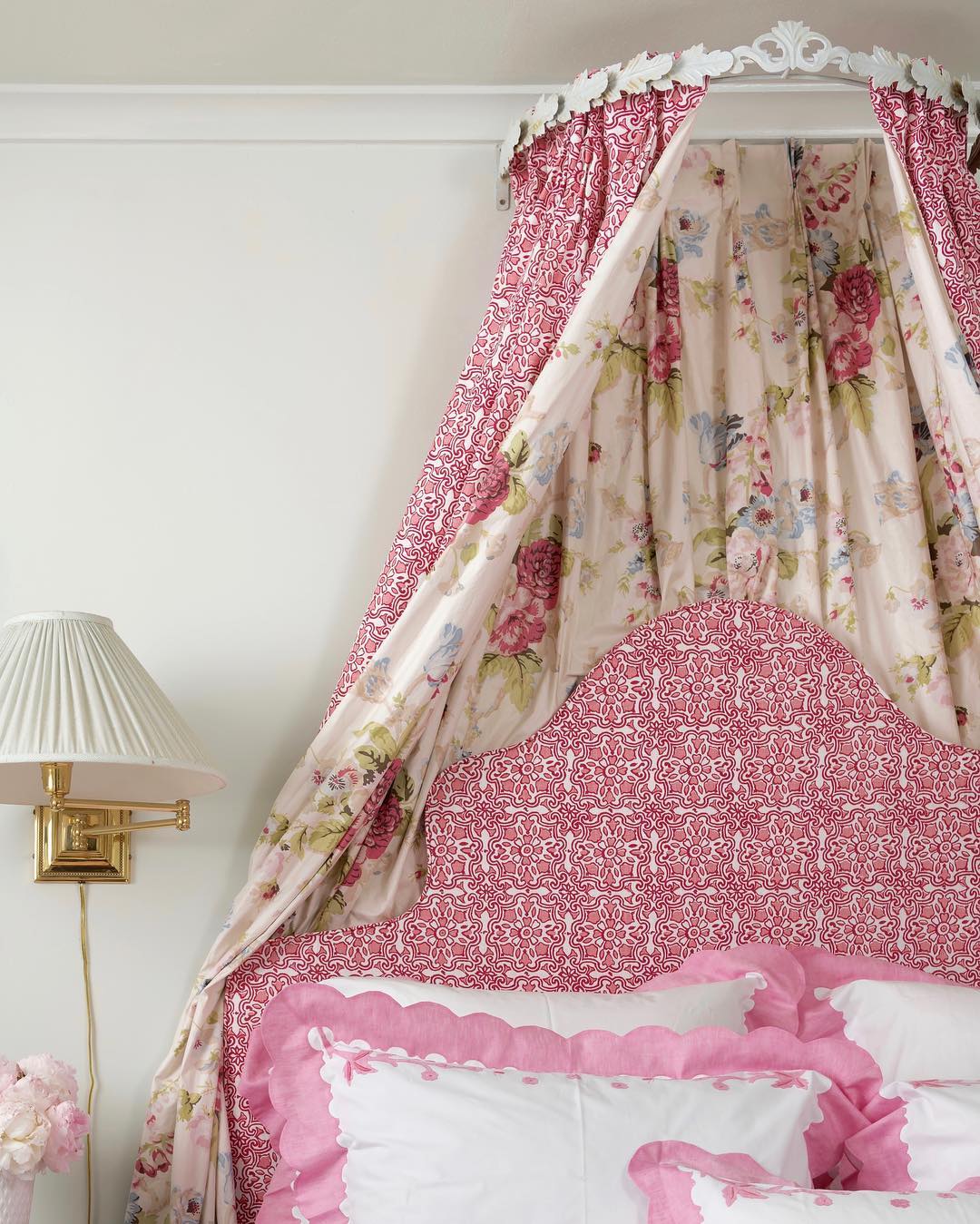 Pink canopy bed with florals by Blithfield Fabrics.