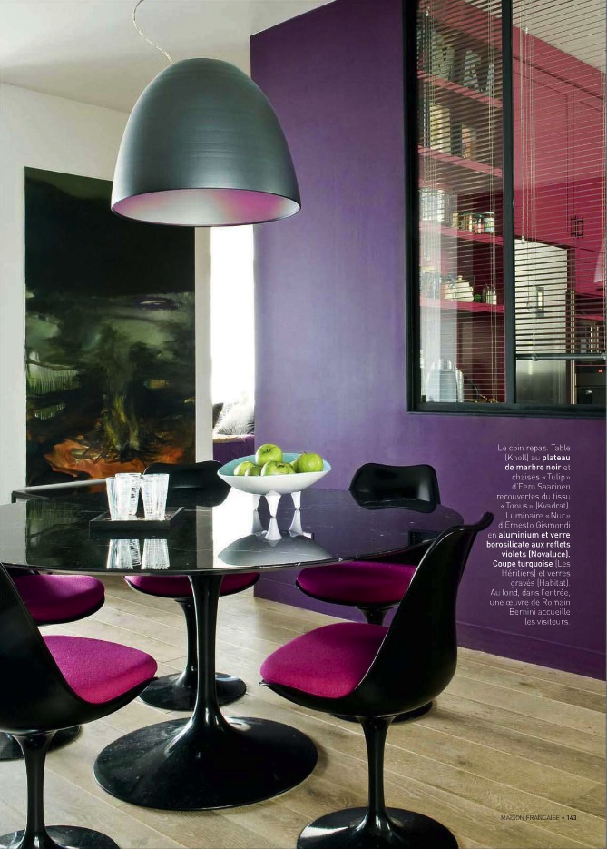 Saturated purple dining room walls and hot pink and black dining chairs, contempoary dining room in a purple and pink color scheme.