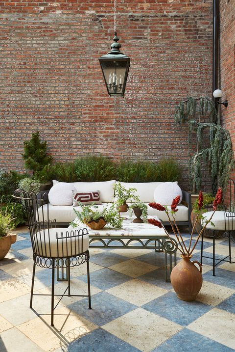 Patio with blue and white checkered floor and brick walls