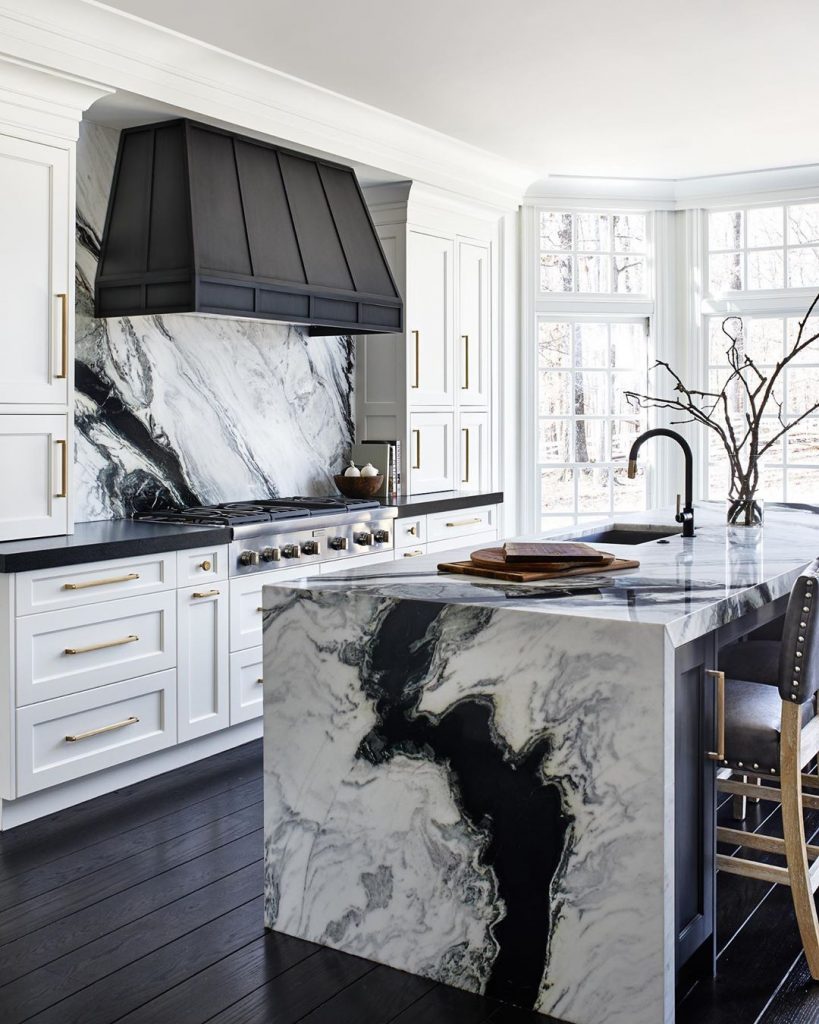 Kitchen with black and white vein marble splashback and island