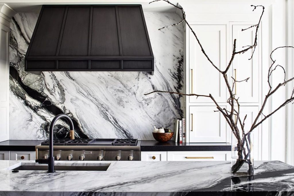 Kitchen with black and white vein marble splashback and island