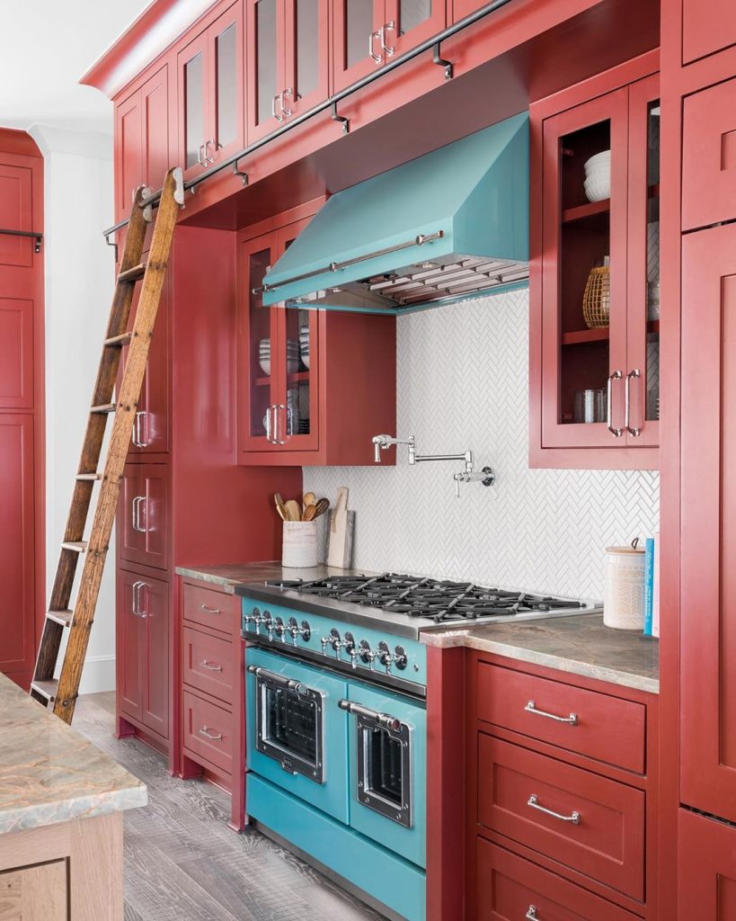 Red kitchen cabinets painted in Benjamin Moore Dinner Party  blue rangehood