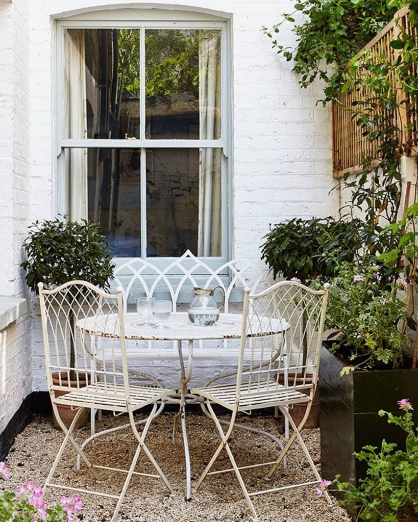 Small patio decor with cast iron chairs and table