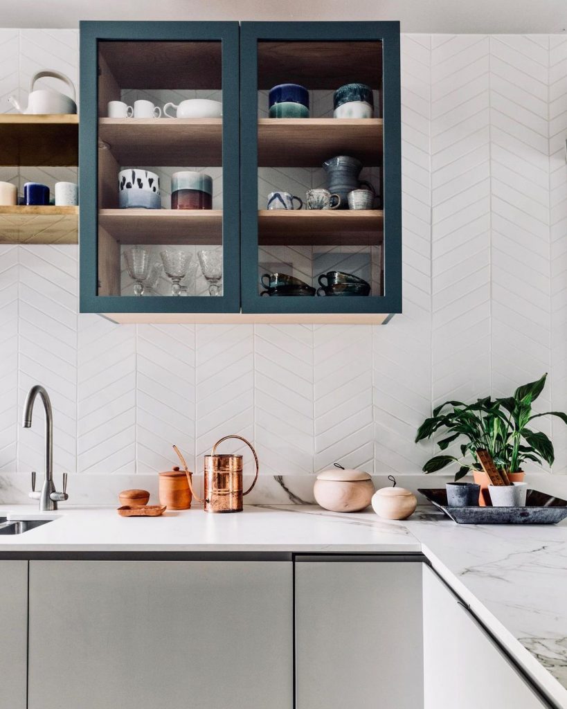 White and green kitchen with herringbone tiles