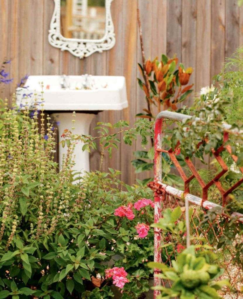 Gardening with old metal gate and sink