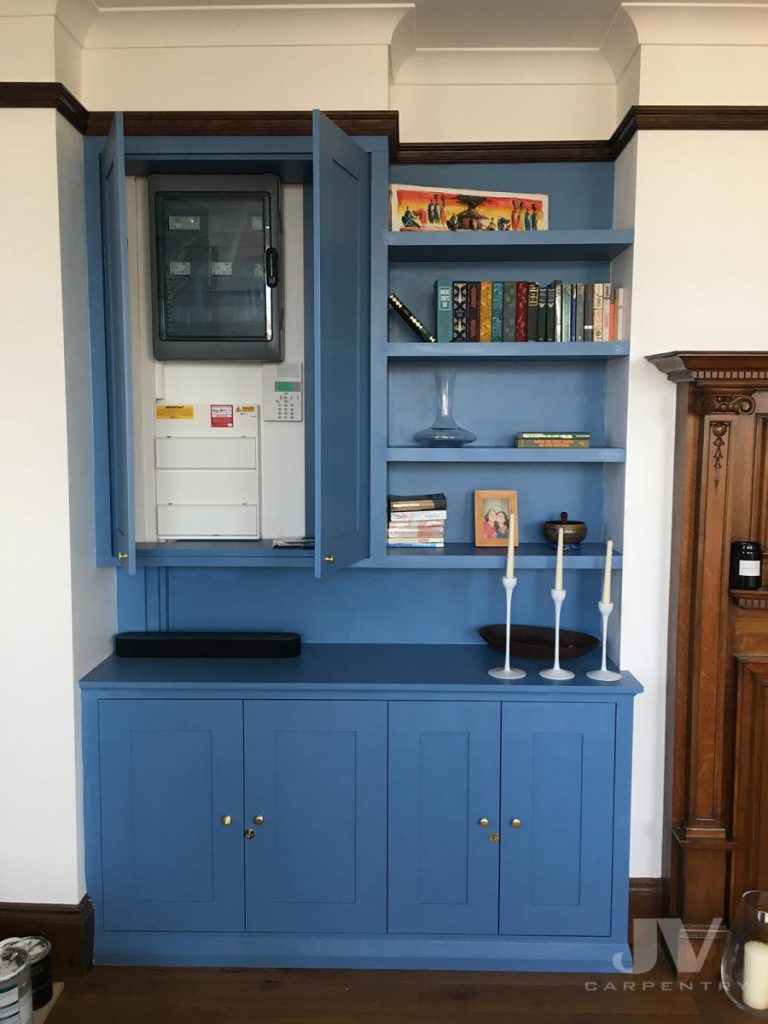 blue painted built in shelves in an alcove