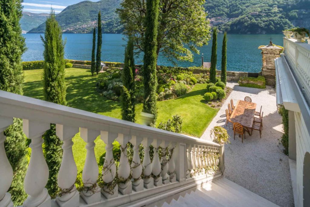 staircase leading to a garden and a lake