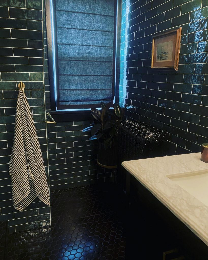 Moody dark green bathroom design idea