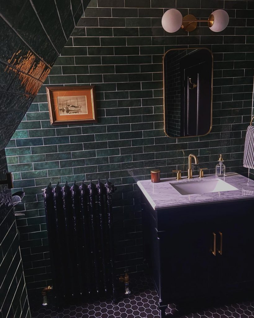 Moody dark green bathroom design idea