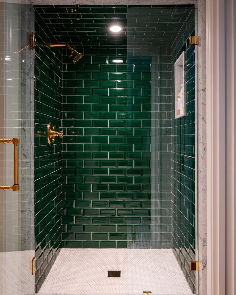 green and brass bathroom with beveled tiles