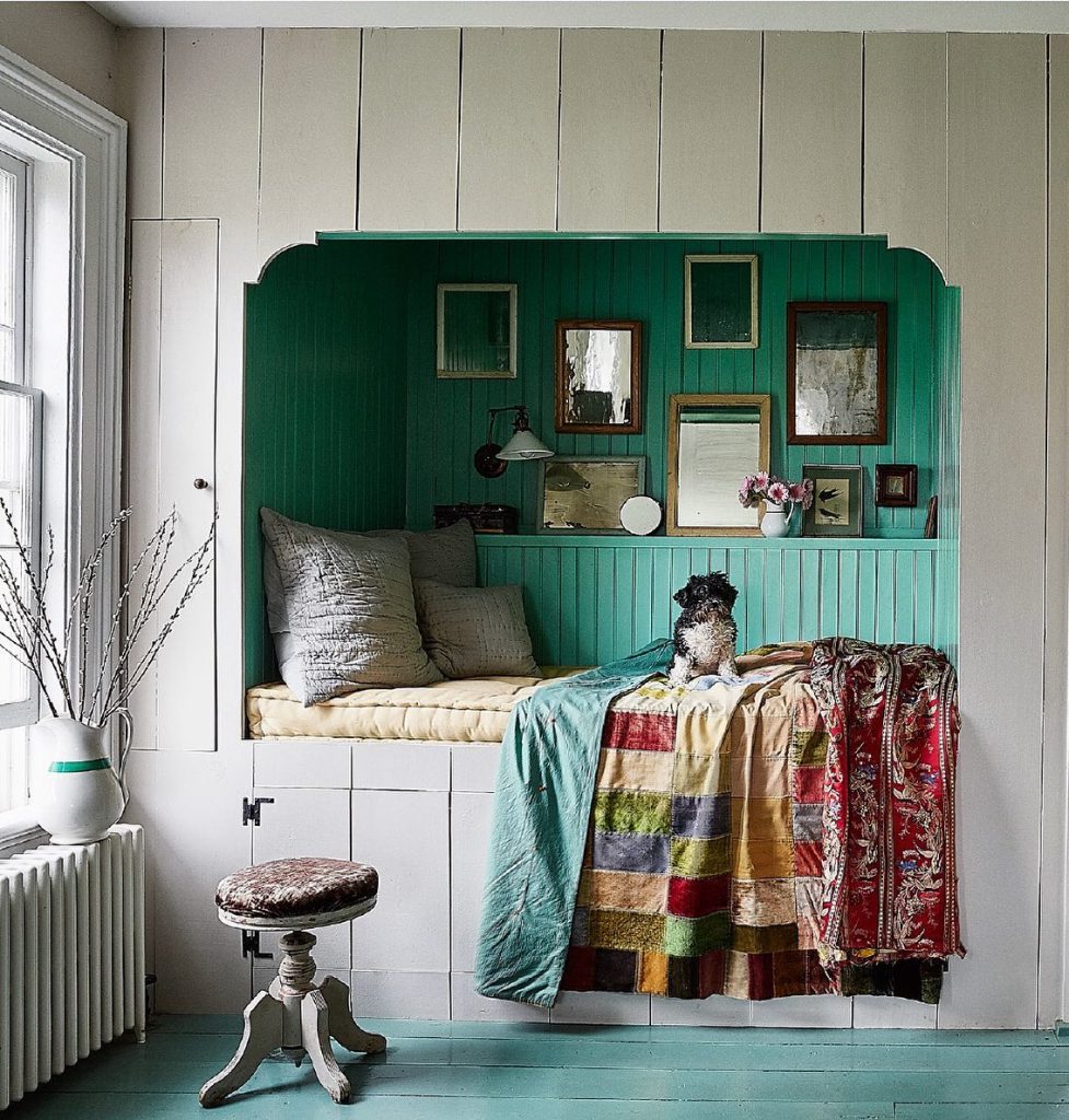 Grey and green built-in bed with green painted floorboards