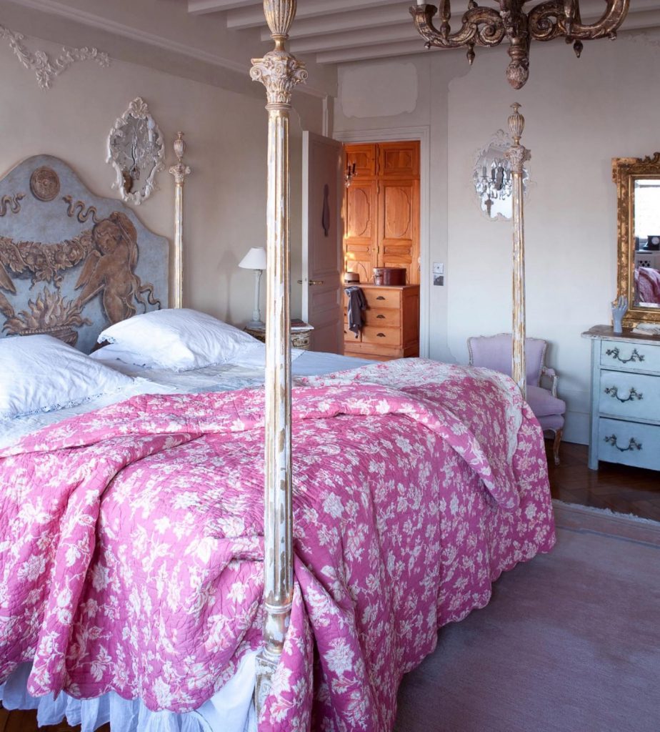 Lovely romantic French country bed with four poster bed, ornate headboard and pink floral bedding