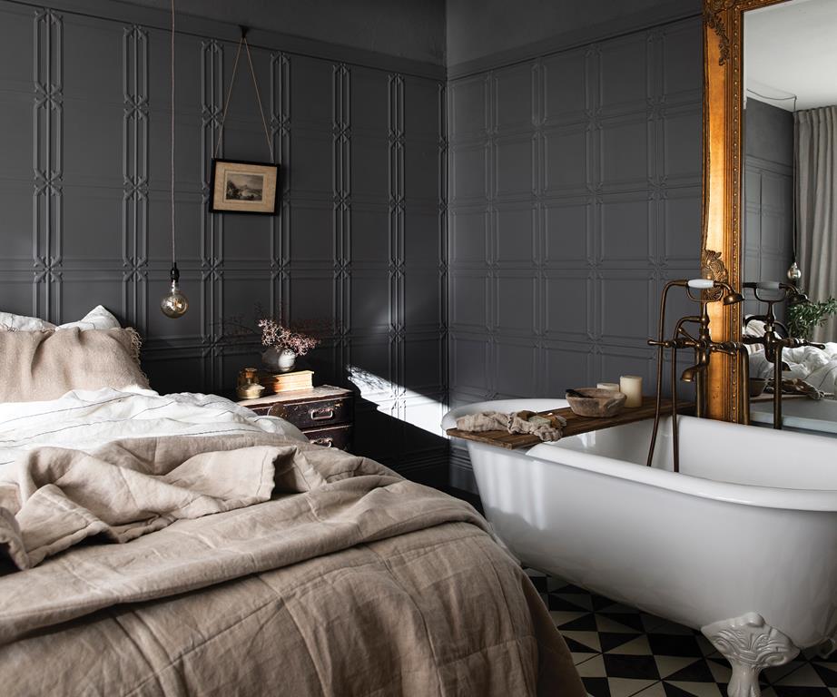 gray master bedroom with clawfoot tub
