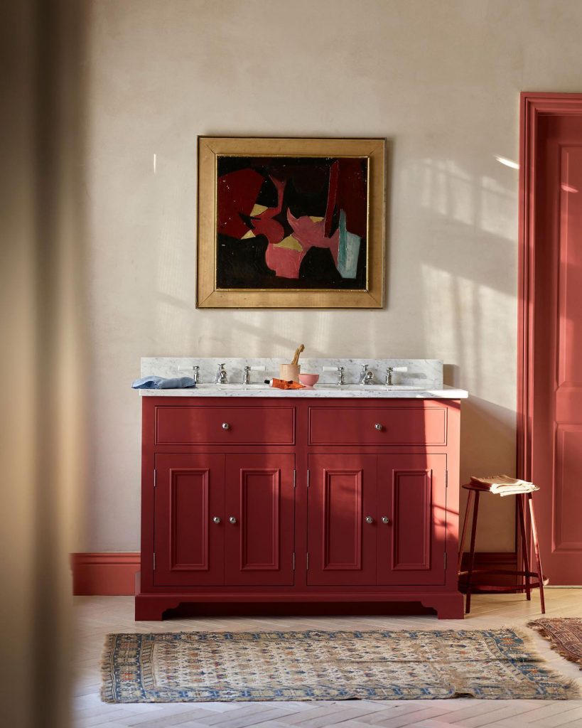 bathroom with a red vanity and trim